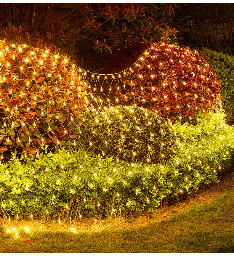 Warm LED net lights illuminating garden bushes at night