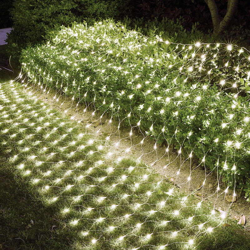 LED net lights creating a bright even pattern across green shrubs