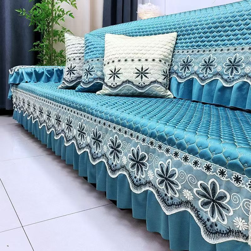 Blue embroidered quilted sofa cover detail