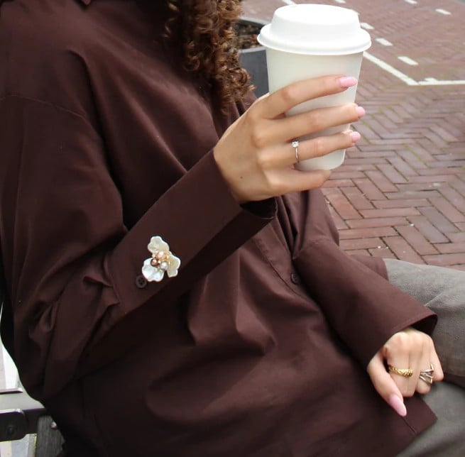 Luxury flower button cover on brown outfit cuff